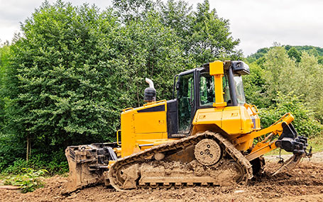 Worker driving heavy equipment